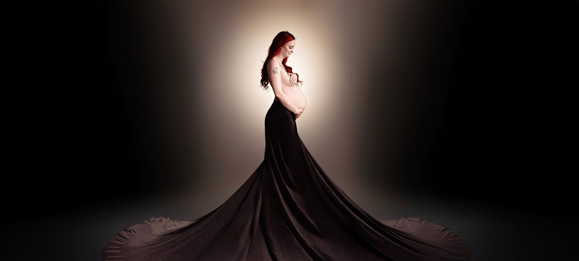 Maternity portrait in a flowing black gown